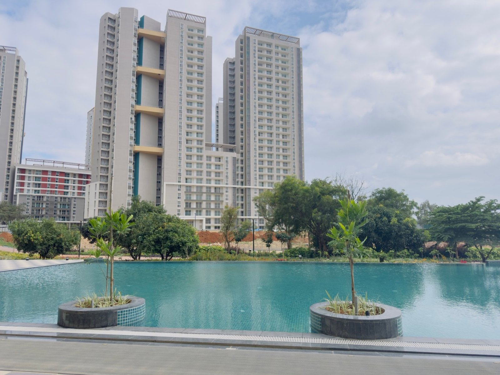 Mana Scanda residential towers seen across landscaped water